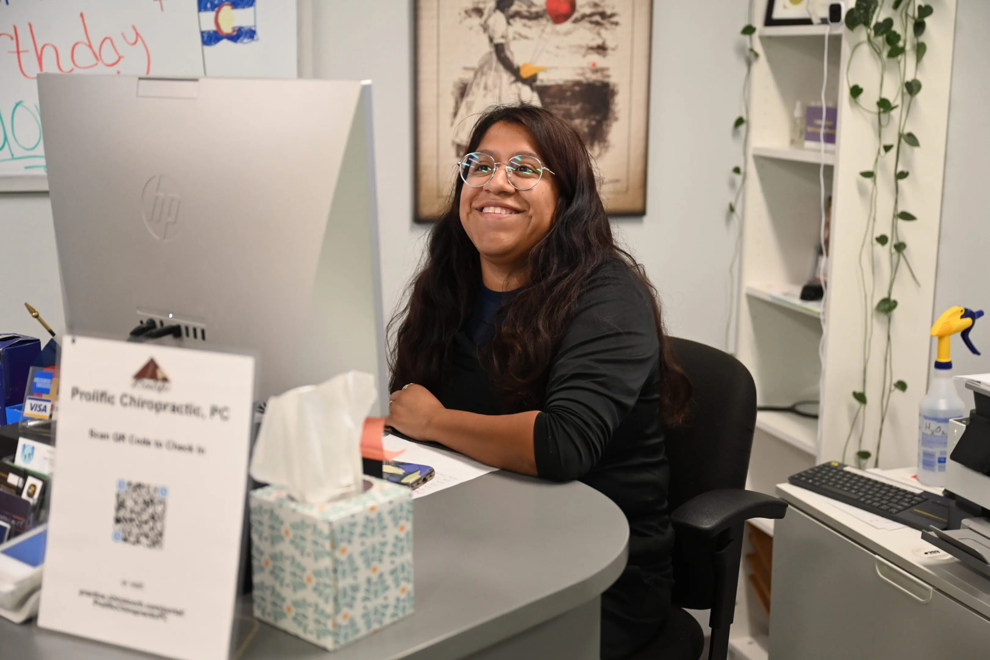 Person smiling at a desk