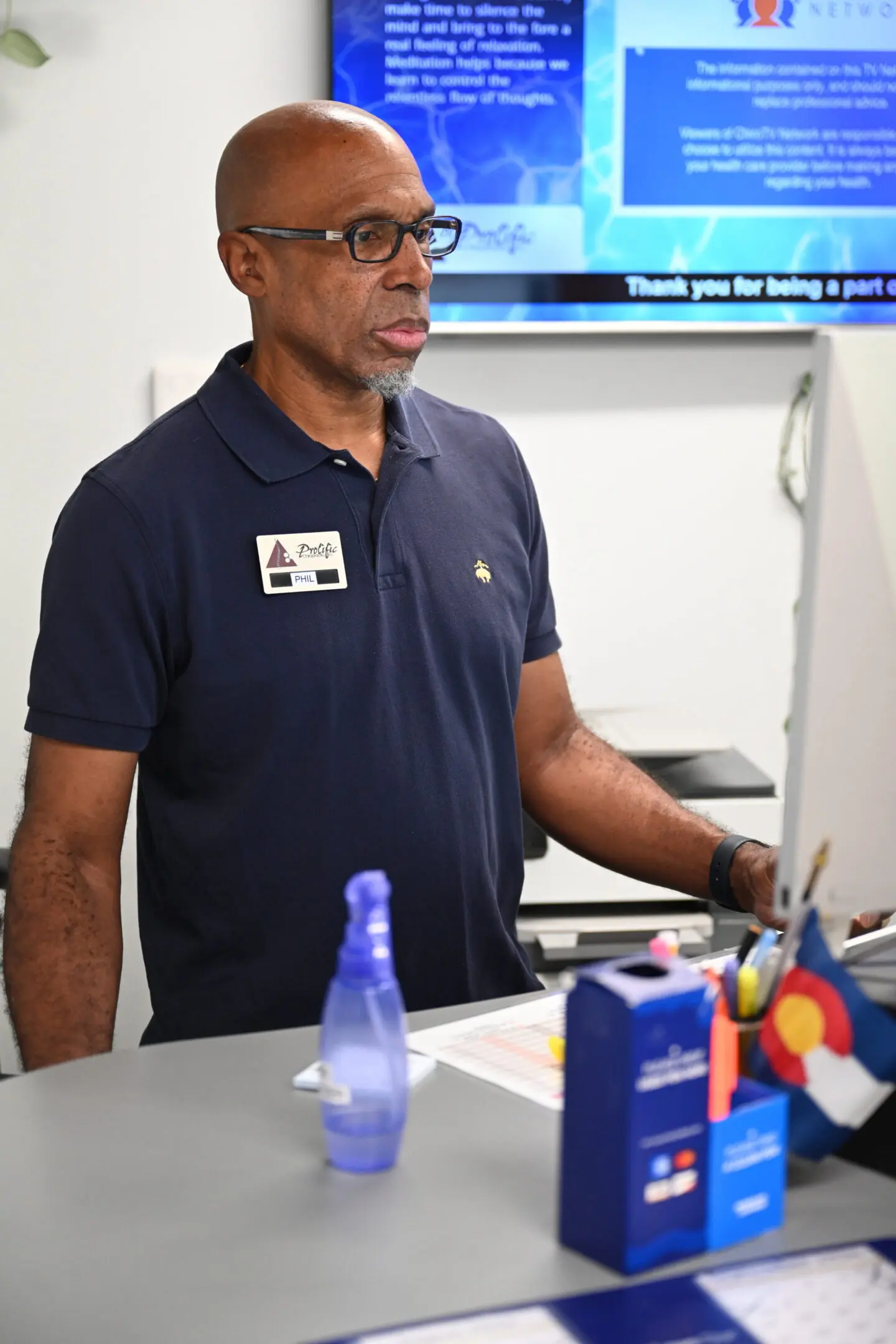 Employee standing at office workstation