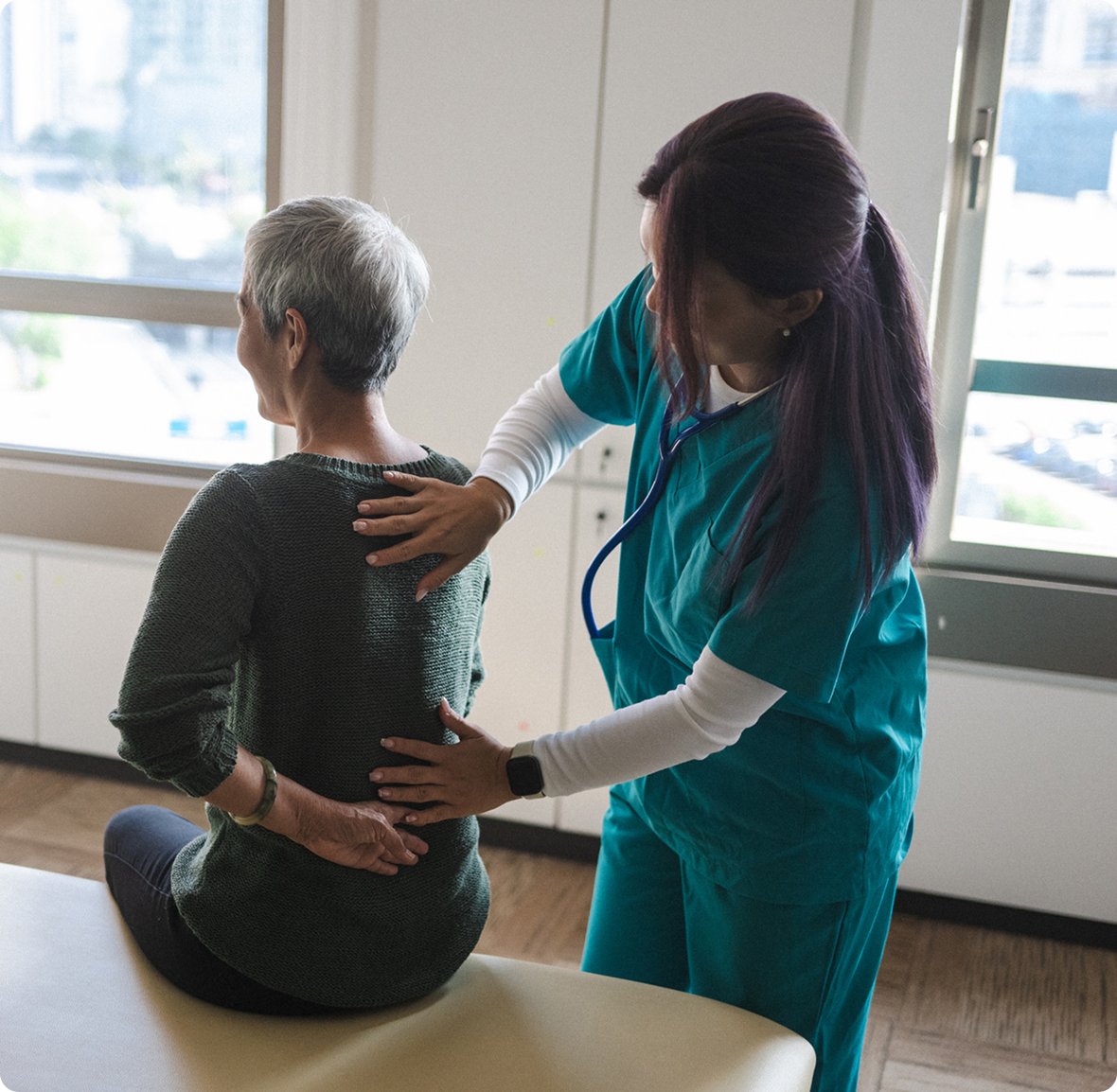 Medical practitioner helping with back pain therapy