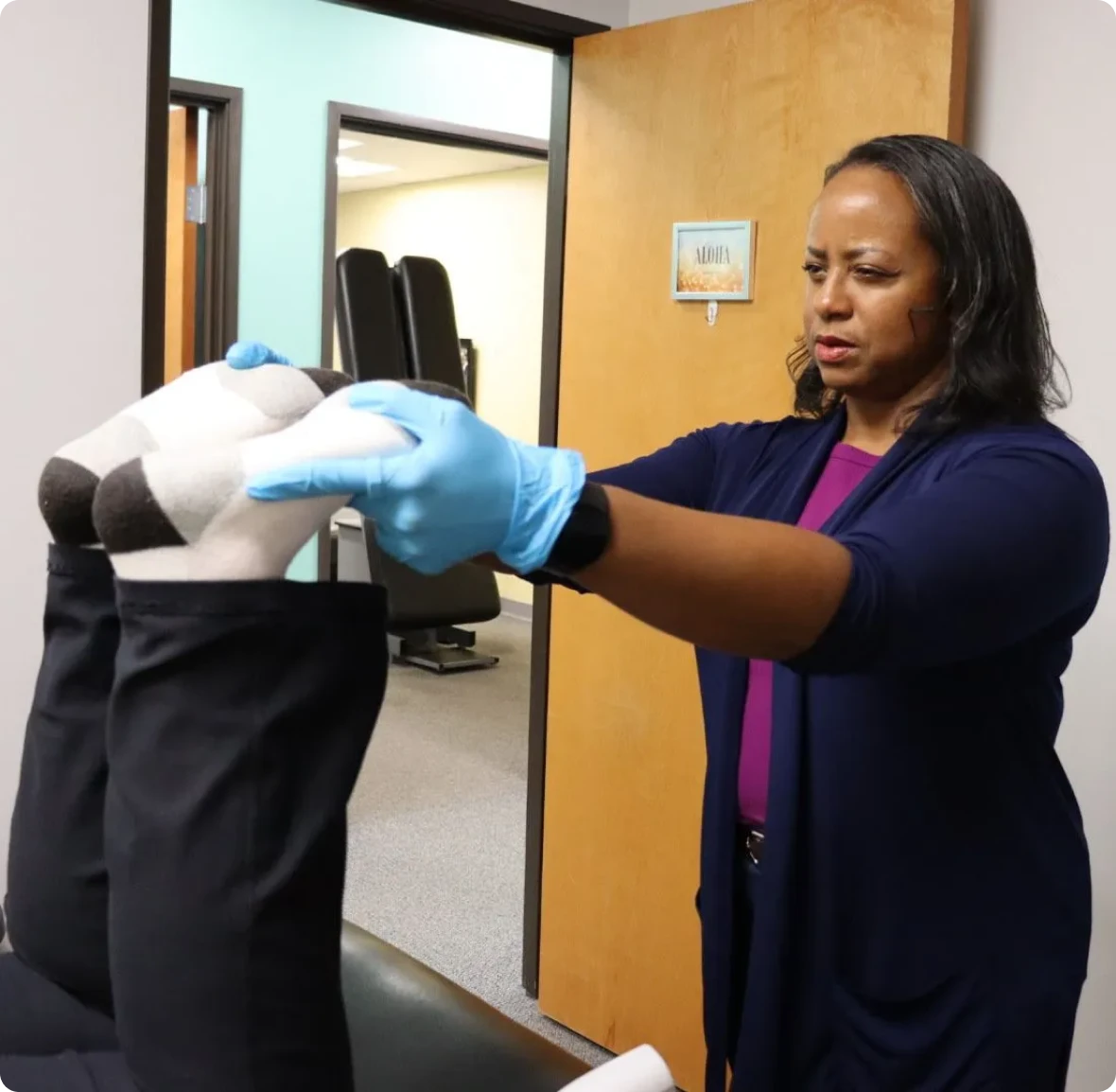 Chiropractor adjusting patient's legs
